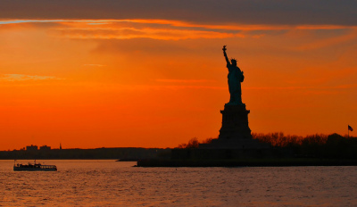 Lady Liberty and a Boat at Sunset